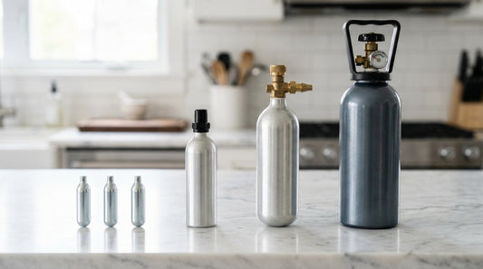 N2O cream charger sizes comparison: 8g cartridges to 2000g tanks on a marble counter