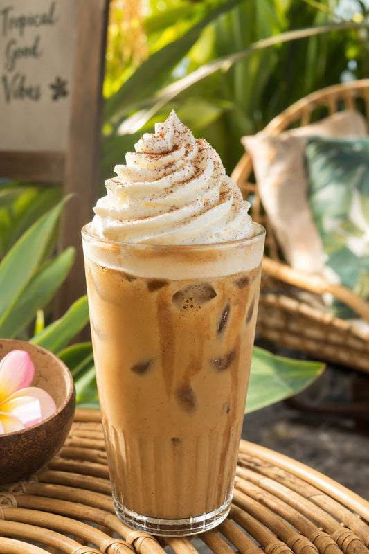 Stabilized whipped cream holding stiff peaks on iced coffee in a tropical Bangkok café